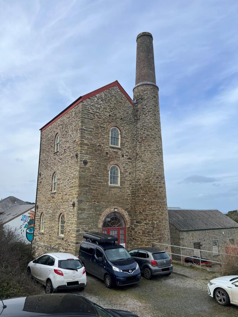 Lot: 132 - FORMER ENGINE HOUSE IN GREAT LOCATION - Rear elevation of Engine House with parking area